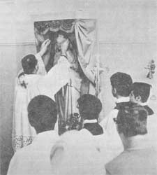 Priest crowning Mary in Assumption Chapel