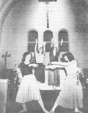 Four girls dancing in the sanctuary during the Offertory
