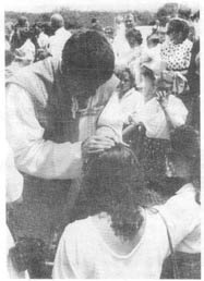 Fr. Tague blesses a woman among the crowd
