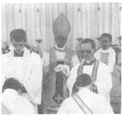 Ordained priests impose hands on the ordinands
