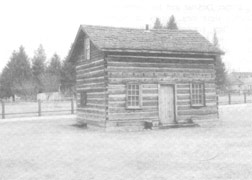 Small, tidy, two-storey log house