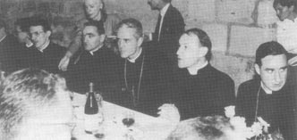 More bishops and priests sit at a table at the reception