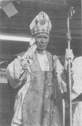 Archbishop Lefebvre, holding mitre and crozier, speaks before a crowd at his 60th Jubilee