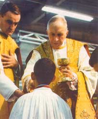 Archbishop Lefebvre giving Holy Communion to an altar boy