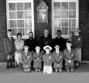 Bishop with children in uniform